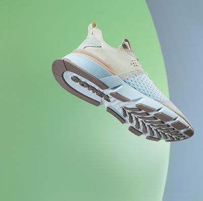 A men's sneaker on a colorful background