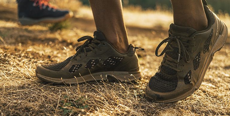 A person in Vitesse sneakers outdoors. 