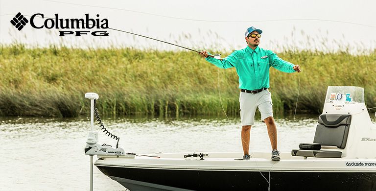 A man wearing PFG fly fishing from a boat. 