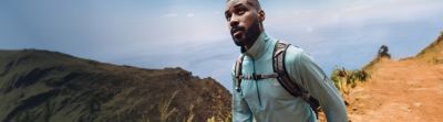 Two people hiking on a rocky coastline trail with Summer Sale Up TO 50% Off