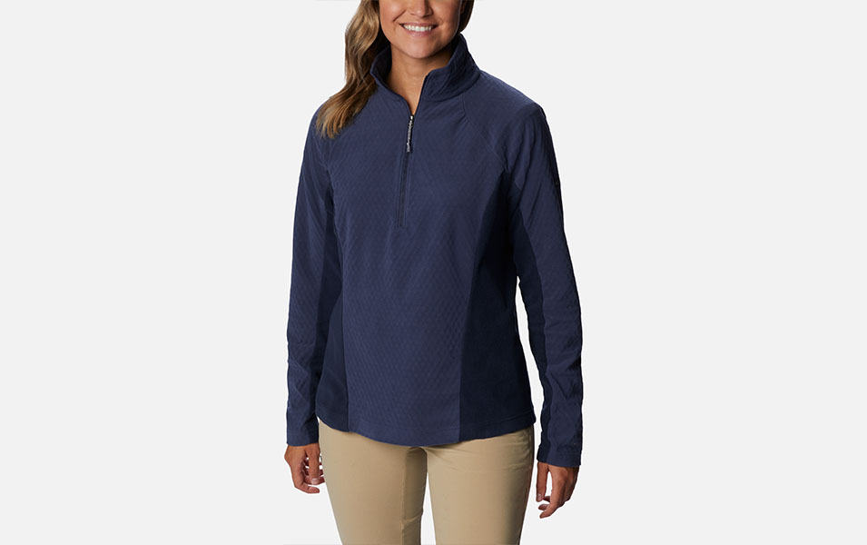 A product image of a woman wearing Columbia Sportswear’s Overlook Pass Half Zip Pullover against a white background.