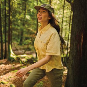 A hiker exploring a sunny forest.