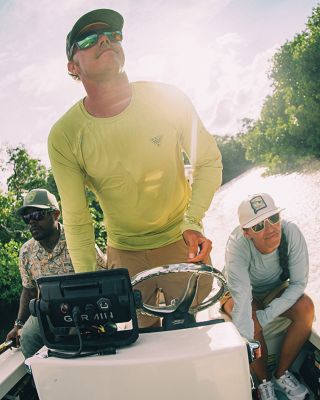 Group of people wearing PFG on a boat.