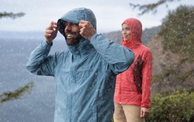 Two people hiking in the rain wearing Columbia Sportswear gear.