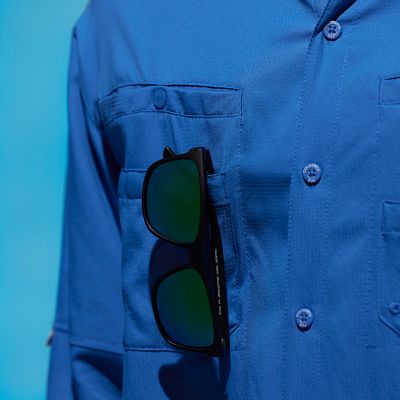 Close up of right chest pockets with a pair of sunglasses hanging from one of them.