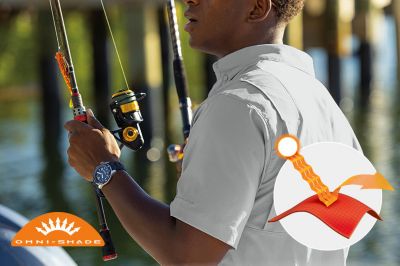 Model in profile casting a line in the blue Tamiami button up shirt. Omni-Shade logo is on the bottom left and a graphic showing how the sun's rays are blocked by fabric is on the bottom right.