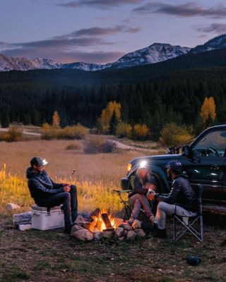 Camper setting up a campfire.