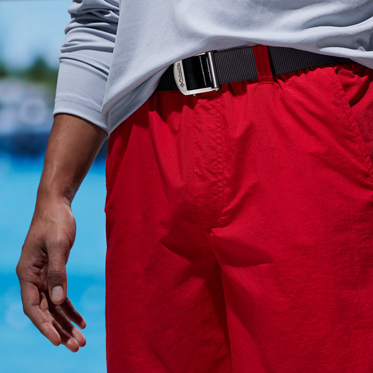 Close up of waist of the bright red water shorts with the model wear a belt to show the versatility.