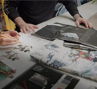 Two designers working on a special-edition Disney collection featuring Mickey Mouse.