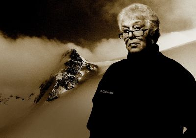 Gert Boyle standing in front of a mountain backdrop.