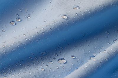 Close up of blue fabric showing how moisture rises to the surface of the fabric to evaporate.