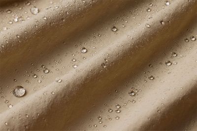 Close up of tan fabric showing how moisture rises to the surface of the fabric to evaporate.