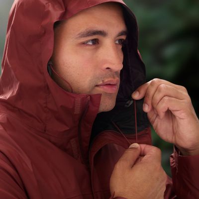 A man adjusts the hood to seal out the elements.
