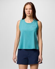 A woman wearing a blue top and shorts.