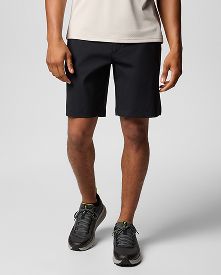 A leg down image of a man wearing black shorts.
