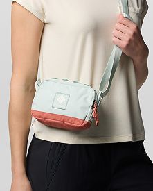 An image of a model wearing a small crossbody bag.