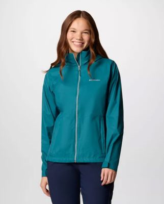 A woman wearing a teal rain jacket.
