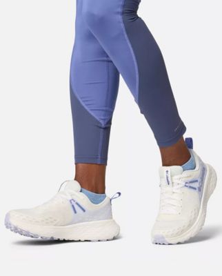 A single white and blue trail running shoe.
