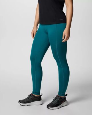 Waist-down image of a woman wearing teal leggings.