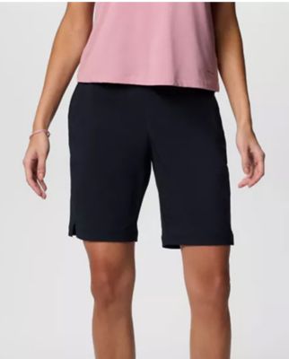 Waist-down image of a woman wearing navy shorts.