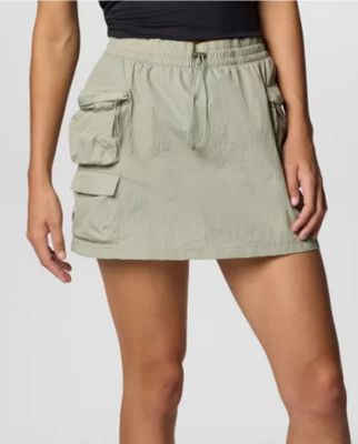 Waist-down image of a woman wearing a light green skort.