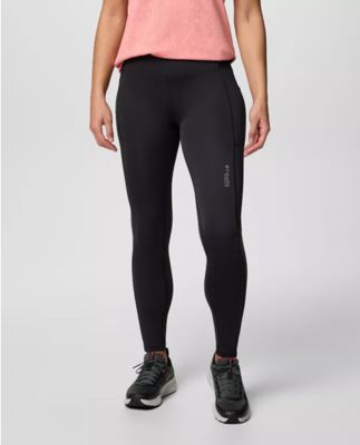 Waist-down image of a woman wearing black leggings and sneakers.