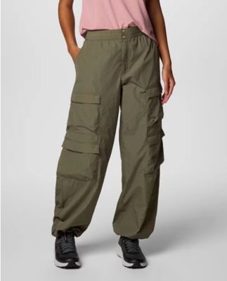 Waist-down image of a woman wearing relaxed cargo pants and sneakers.