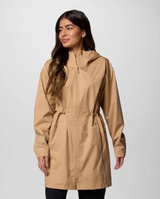⁨Woman wearing a tan rain jacket.
