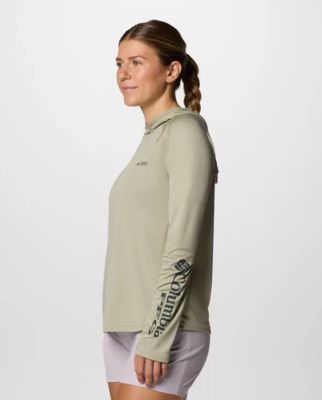 Woman wearing a light green sun hoodie.