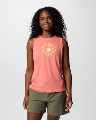 Woman wearing a pink tank top with a graphic on the front.