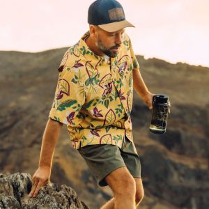 A man hiking with a water bottle in hand.