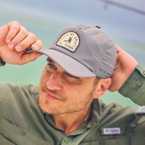 A man putting on a hat.
