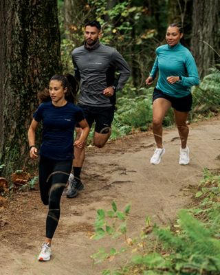 3 people trial running in the forest 