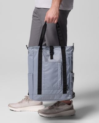 Waist-down image of a man holding a grey tote bag.