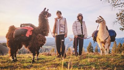 A Heritage collection video showing hikers on a hill with llamas and snow-capped mountains in the background. They're wearing the latest gear inspired by Oregon's Wallowa Mountains.