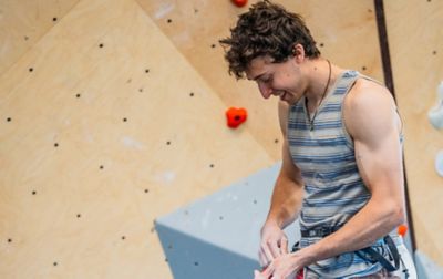 US Climbing Team member/Olympic athlete, Jesse Grupper, tying a figure eight knot before climbing in an indoor gym. 