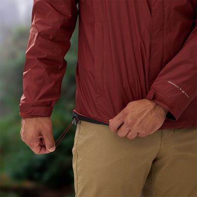 A model cinching the waist of the jacket for a snug and comfortable fit.