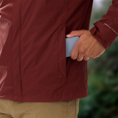 A close-up of a model dropping their phone into the hand pocket.