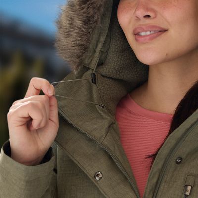 Close-up of a model using the drawcord on her hood to adjust the fit.