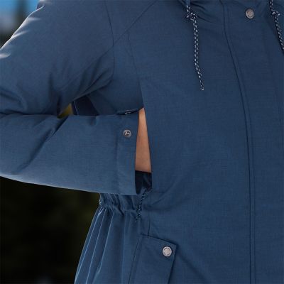 Close-up of a woman with her hand warming up in the chest pocket.