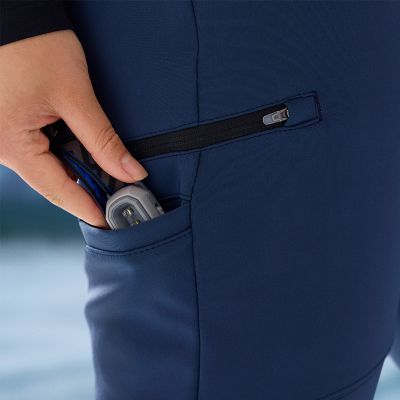 Model slipping a headlamp into the drop-in leg pocket.