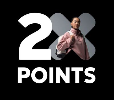 A girl wearing a backpack with text: 2X Points