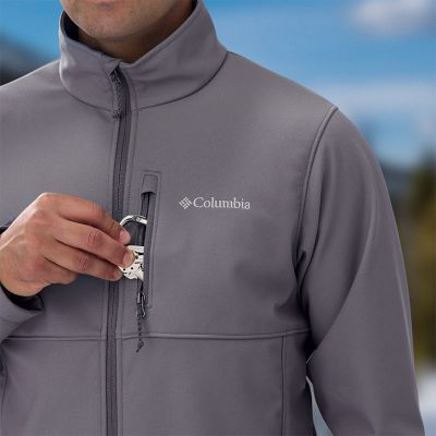 Model placing keys into the chest zip pocket.