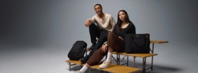 Two college students sitting on bleachers.