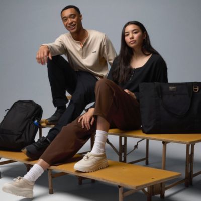 Two kids sitting on risers in back-to-school gear.