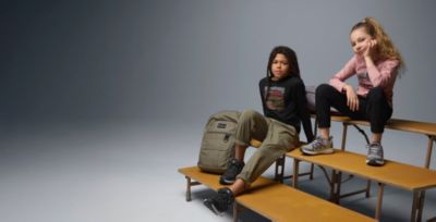 Kids on bleachers in back to school gear.