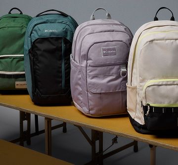 Backpacks lined up on bleachers.