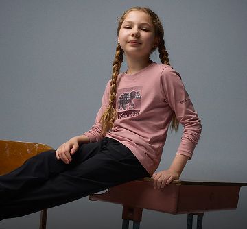 A girl sitting on a school desk.