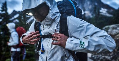 A person wearing an OutDry Extreme Eco jacket in a rainstorm.