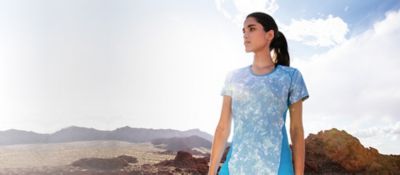 Woman standing in the sun in a high desert landscape.